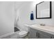 Clean, neutral bathroom with gray vanity, modern fixtures and tile flooring at 872 Beryl Sw St, Atlanta, GA 30310