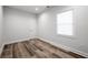 Clean bedroom with natural light, wood look flooring, white walls and trim at 872 Beryl Sw St, Atlanta, GA 30310