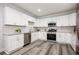 Modern kitchen with stainless steel appliances, granite countertops and white cabinets at 872 Beryl Sw St, Atlanta, GA 30310