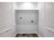 A convenient laundry room includes a washer and dryer hookup with a shelf for added storage at 872 Beryl Sw St, Atlanta, GA 30310