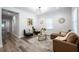 Inviting living room featuring a large window, modern decor and wood look flooring at 872 Beryl Sw St, Atlanta, GA 30310
