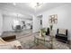 Open-concept living and dining area with modern light fixtures and gray wood flooring at 872 Beryl Sw St, Atlanta, GA 30310