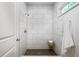 Modern tiled shower featuring white marble-style large format tile and a window at 872 Beryl Sw St, Atlanta, GA 30310