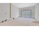 Bright bedroom featuring a large sliding glass door and modern wall paneling at 120 Wood River Ct, Johns Creek, GA 30097