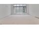 This bedroom has large window, white walls, and flooring ready for carpet or hard surface at 120 Wood River Ct, Johns Creek, GA 30097