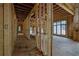 Unfinished hallway with exposed wooden framing, showcasing potential for arched doorways and custom design at 120 Wood River Ct, Johns Creek, GA 30097