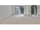 Bright living room featuring a large window and an arched doorway at 120 Wood River Ct, Johns Creek, GA 30097