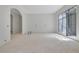 Open living room area featuring an arched doorway and large window at 120 Wood River Ct, Johns Creek, GA 30097