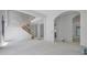 Spacious open-concept room with stairs and arched doorway at 120 Wood River Ct, Johns Creek, GA 30097