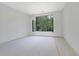 Spacious room featuring natural light, awaiting finishing touches to enhance the living space at 120 Wood River Ct, Johns Creek, GA 30097