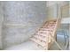 Staircase under construction with a stone accent wall, showcasing modern home elements at 120 Wood River Ct, Johns Creek, GA 30097