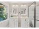 Bathroom featuring double vanities, modern fixtures, and a glass-enclosed shower with a soaking tub at 1995 Venetian Sw Dr, Atlanta, GA 30311