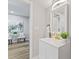 Bathroom with new vanity, modern fixtures, and decor and views into an adjacent living area at 1995 Venetian Sw Dr, Atlanta, GA 30311