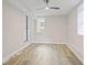 Bedroom features a modern ceiling fan, hardwood floors, and natural light from windows at 1995 Venetian Sw Dr, Atlanta, GA 30311
