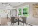 Bright dining area featuring a round table, four chairs, and a large window with a view of the outdoors at 1995 Venetian Sw Dr, Atlanta, GA 30311