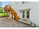 Back of a renovated home with stairs leading to the yard and a walk-out basement at 1995 Venetian Sw Dr, Atlanta, GA 30311