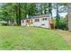 Home exterior featuring a well-manicured lawn and a deck with wooden railings at 1995 Venetian Sw Dr, Atlanta, GA 30311