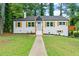 Charming home with a brick facade, a light blue front door, and wooden shutters at 1995 Venetian Sw Dr, Atlanta, GA 30311