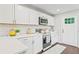 Bright kitchen with white cabinetry, stainless steel appliances, and a window providing natural light at 1995 Venetian Sw Dr, Atlanta, GA 30311