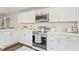 Modern kitchen with white cabinets, stainless steel appliances, and quartz countertops with subway tile backsplash at 1995 Venetian Sw Dr, Atlanta, GA 30311