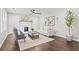 Inviting living room with a white fireplace, comfortable seating, and hardwood floors at 1995 Venetian Sw Dr, Atlanta, GA 30311