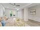 Bright, finished basement with light gray walls and wood floors leading out to the backyard at 1995 Venetian Sw Dr, Atlanta, GA 30311