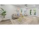 Cozy, light gray living area with stylish area rug and decorative pillows and views out to the backyard at 1995 Venetian Sw Dr, Atlanta, GA 30311