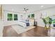 Spacious main bedroom with hardwood floors, a ceiling fan, and plenty of natural light from the large windows at 1995 Venetian Sw Dr, Atlanta, GA 30311