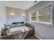 Bathroom showcases a luxurious soaking tub with tile surround and decorative lighting at 202 Heights, Canton, GA 30114