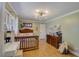 Bright bedroom with hardwood floors, a large bed, lots of room, and natural lighting at 202 Heights Pl, Canton, GA 30114