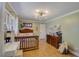 Bright bedroom featuring hardwood floors, ample natural light, and a decorative light fixture at 202 Heights, Canton, GA 30114