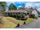 Attractive home with well-manicured lawn, landscaped garden, and a spacious driveway leading to a two-car garage at 202 Heights, Canton, GA 30114