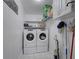 A practical laundry room equipped with a modern washer and dryer, ample storage, and shelving at 202 Heights Pl, Canton, GA 30114