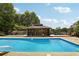 Inviting backyard pool with a gazebo and sundeck surrounded by lush greenery at 202 Heights, Canton, GA 30114