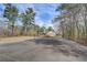 Private tennis court with mature trees and landscaping surrounding property at 202 Heights, Canton, GA 30114