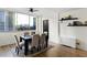 Dining room features large windows with city views, a modern table set, and hardwood floors at 215 Piedmont Ne Ave # 1109, Atlanta, GA 30308