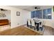 Dining room features hardwood flooring, a dining table set, and large windows with a city view at 215 Piedmont Ne Ave # 1109, Atlanta, GA 30308