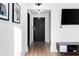 Entryway featuring modern decor, hardwood floors, and a sleek black door at 215 Piedmont Ne Ave # 1109, Atlanta, GA 30308