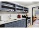 Cozy kitchen featuring gray cabinets, open shelving, white marble countertops, and stainless steel appliances at 215 Piedmont Ne Ave # 1109, Atlanta, GA 30308