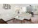Bright living room features hardwood floors, a modern white sofa set, and an area rug at 215 Piedmont Ne Ave # 1109, Atlanta, GA 30308