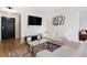 Living room featuring a white sofa set, mounted television, and modern decor at 215 Piedmont Ne Ave # 1109, Atlanta, GA 30308