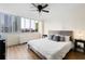 Bright main bedroom featuring hardwood floors, a plush bed, and large windows with city views at 215 Piedmont Ne Ave # 1109, Atlanta, GA 30308