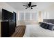 Bright main bedroom featuring hardwood floors, a plush bed, a ceiling fan and large windows at 215 Piedmont Ne Ave # 1109, Atlanta, GA 30308