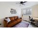 Home office area features a cozy brown sofa, a window, and a desk setup at 215 Piedmont Ne Ave # 1109, Atlanta, GA 30308