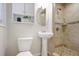 Updated bathroom features a walk-in shower, pedestal sink, and ample storage space at 2383 Edgewater Sw Dr, Atlanta, GA 30311