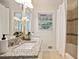 Bathroom with double sinks, granite countertop, and a shower/tub combo with decorative tile at 2383 Edgewater Sw Dr, Atlanta, GA 30311