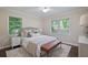 Comfortable bedroom with large windows, plush bedding, and stylish decor at 2383 Edgewater Sw Dr, Atlanta, GA 30311