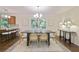 Elegant dining room with modern lighting, stylish furniture, and views of the lush greenery at 2383 Edgewater Sw Dr, Atlanta, GA 30311