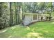 Side view of home on a large, sloped lot with mature trees and a brick facade at 2383 Edgewater Sw Dr, Atlanta, GA 30311