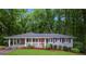 Charming single-story home with a covered carport, landscaped front yard, and red front door at 2383 Edgewater Sw Dr, Atlanta, GA 30311